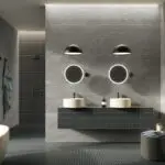Dunkles Badezimmer mit zwei Waschbecken und runden Spiegeln